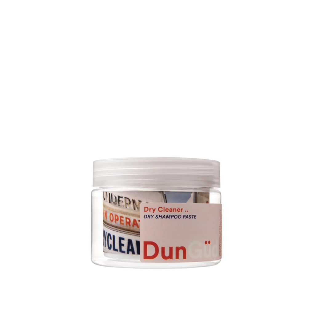 Transparant potje DunGüd Concrete Jungle Dry Shampoo Paste met witte draaiende deksel en kleurrijk etiket.