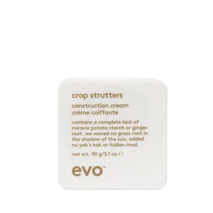 Vierkante witte verpakking van evo crop strutters construction cream van 90 gram met goudkleurige tekst.