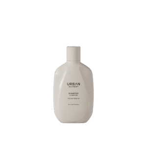 Crèmekleurige fles Urban Alchemy Volume Vibrance shampoo met minimalistisch zwart opschrift.